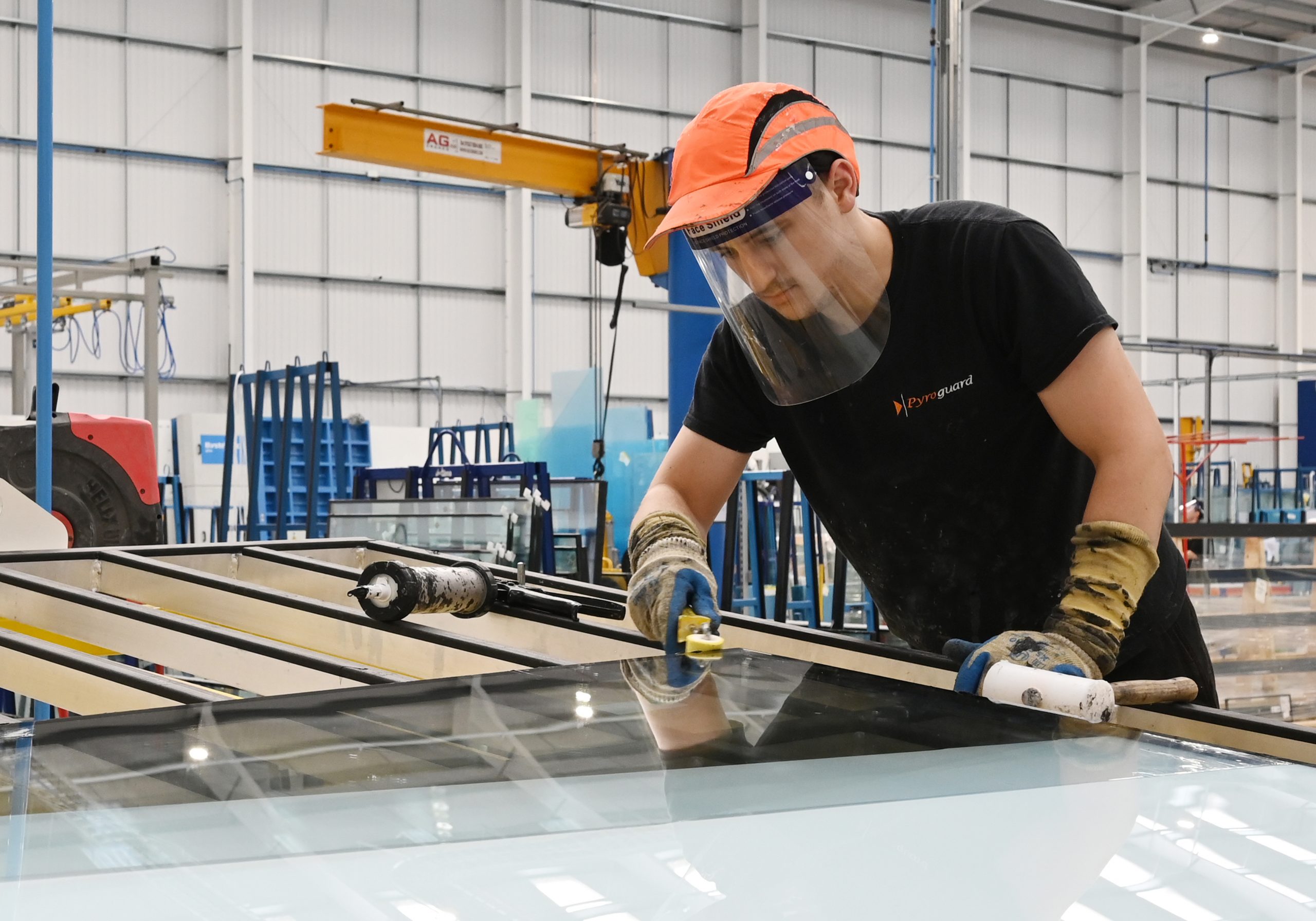 Pyroguard Staff Member Working on Fire Safety Glass In Warehouse